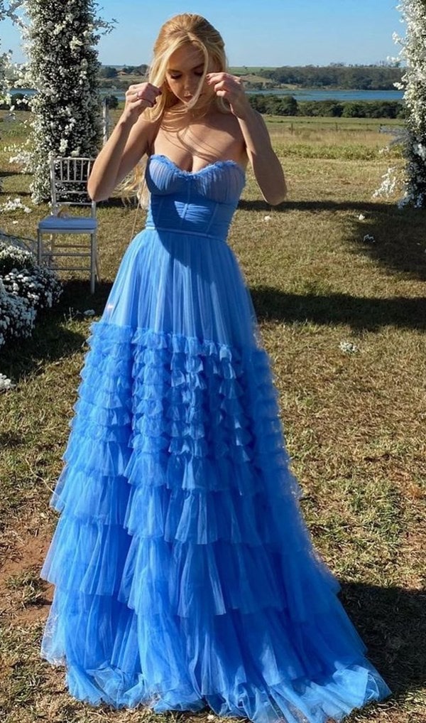 madrinha de casamento no campo usando vestido de festa longo azul céu
